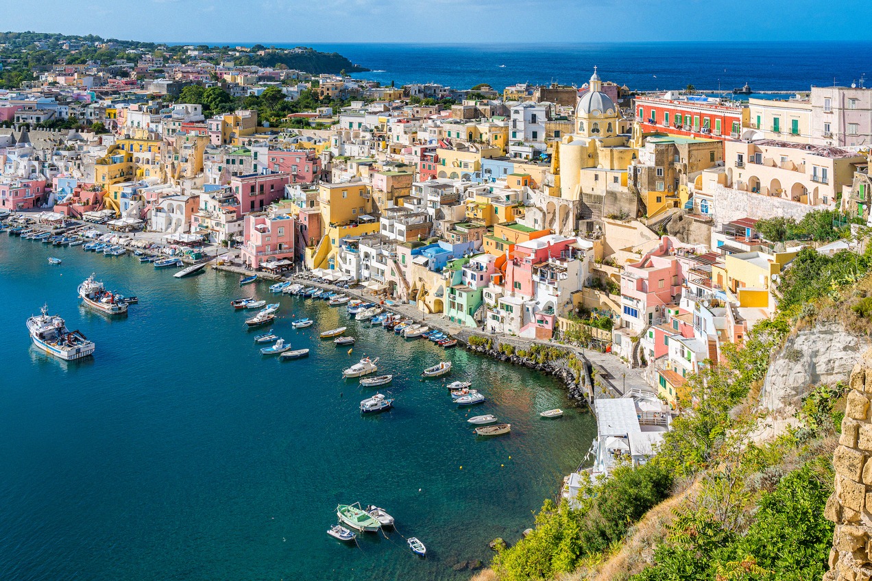 The pastel-coloured harbour front of Marina Corricella on Procida, seen from above