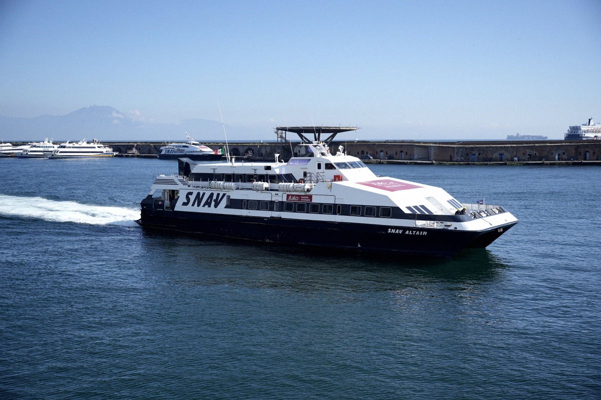 The SNAV Altair fast ferry leaving the port of Naples, with Vesuvius in the haze behind